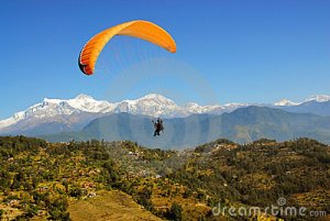 people paragliding over some scenic hills 